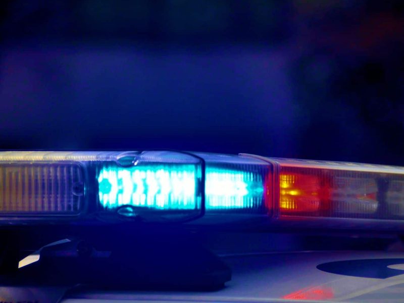 A closeup image of blue and red police lights mounted atop a police car.