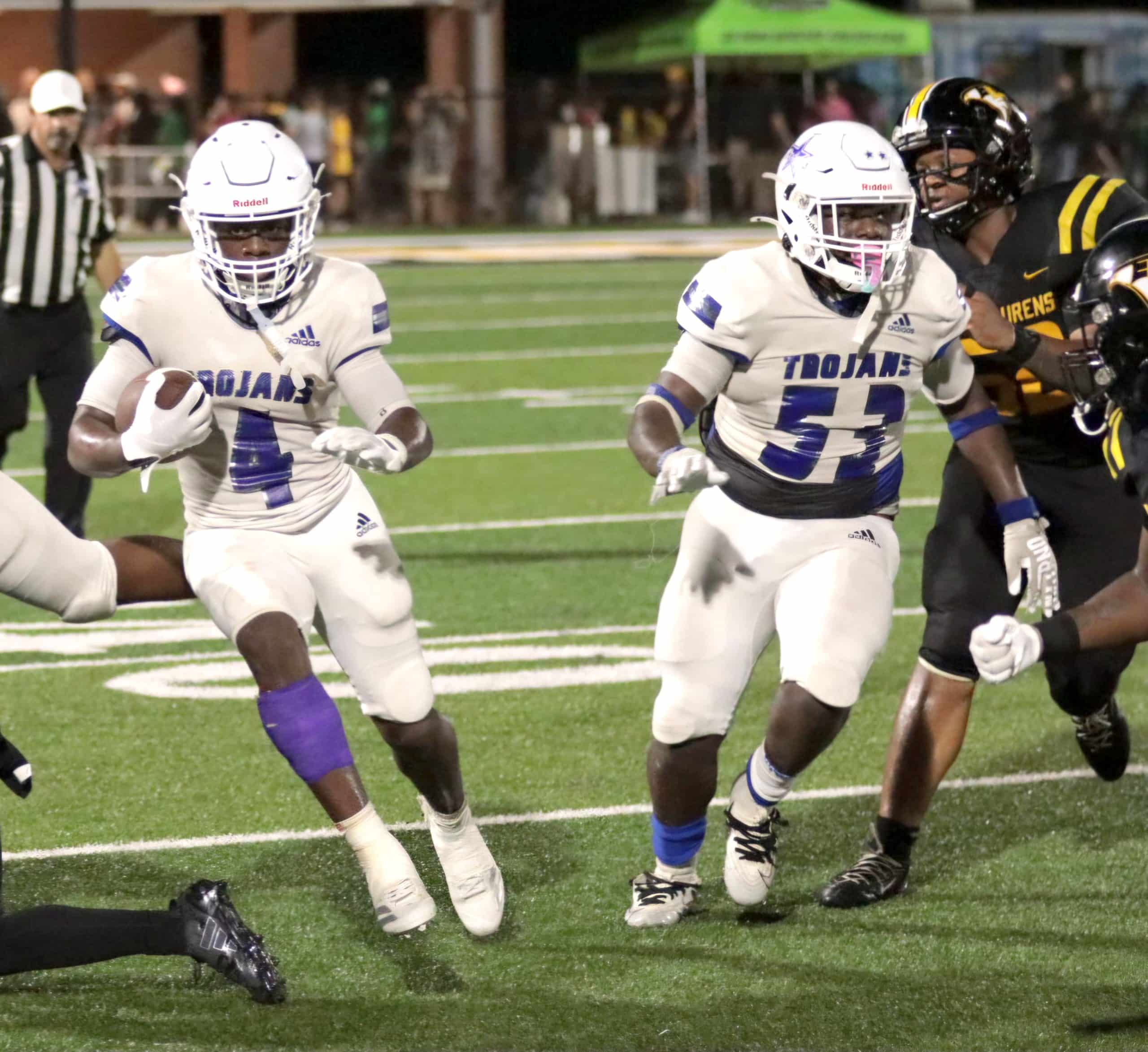 Johnson County Jeremiah Scott rushes against East Laurens